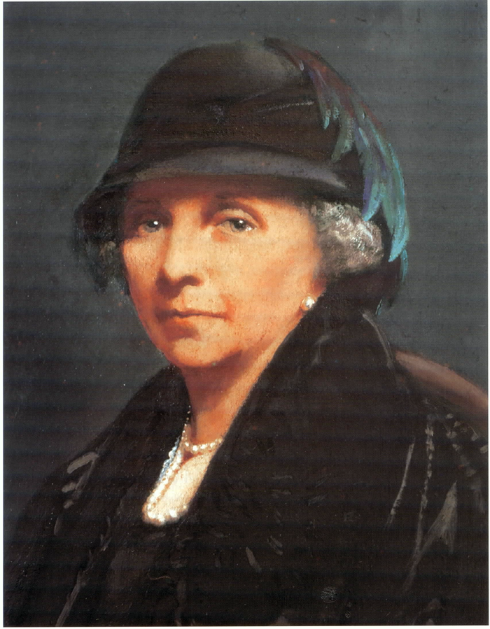 A portrait of a woman with a hat. She is white with short gray hair.