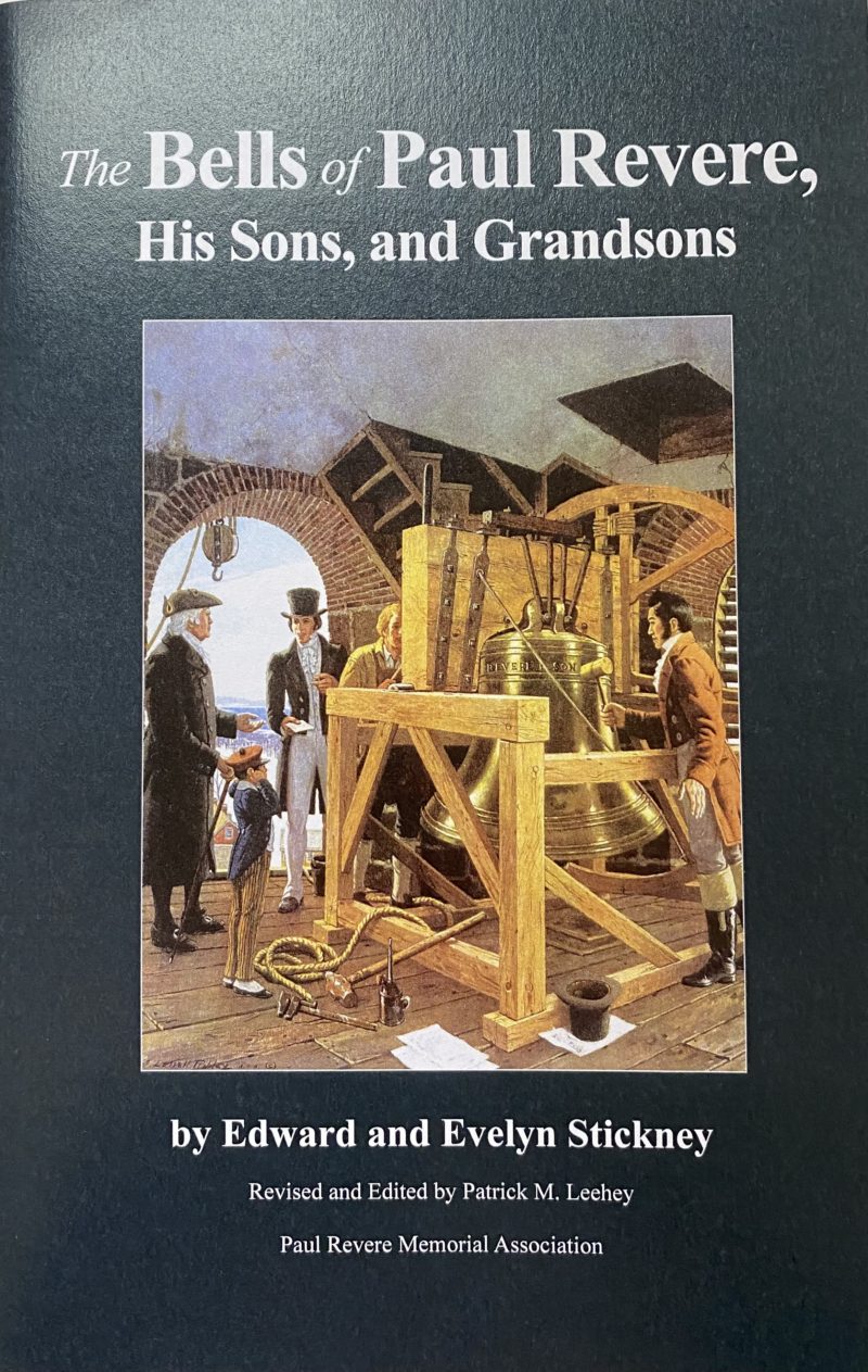 Front cover of a dark blue book with an image of people in a bell tower in the middle
