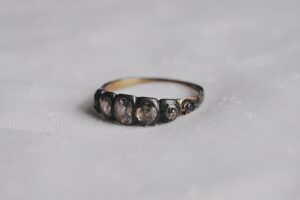 side view of rachel revere's ring on a white tablecloth