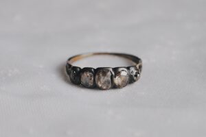 rachel revere's ring on a white tablecloth