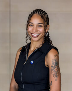 Tenesha Carter Johnson, a Black woman wearing a dark blouse. She is smiling.